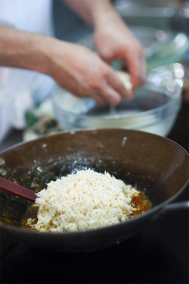 Adding rice to the stove's pot