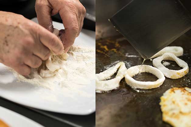 Chef coating the calamari in flour then grilling them