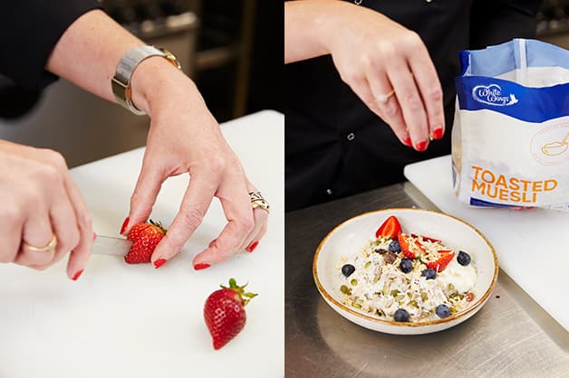 The chef is pictured slicing the strawberries and adding them and blueberries to the bircher