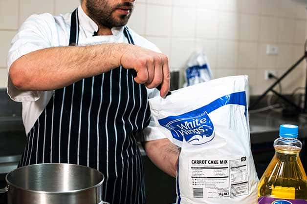 Image shows the chef using the White Wings Carrot Cake Mix