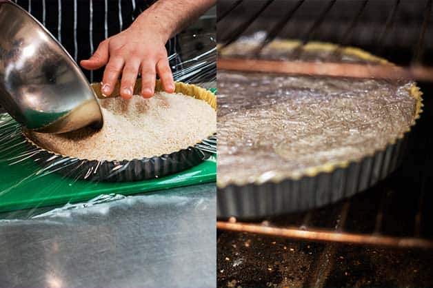 The chef fills the pastry with rice for blind baking
