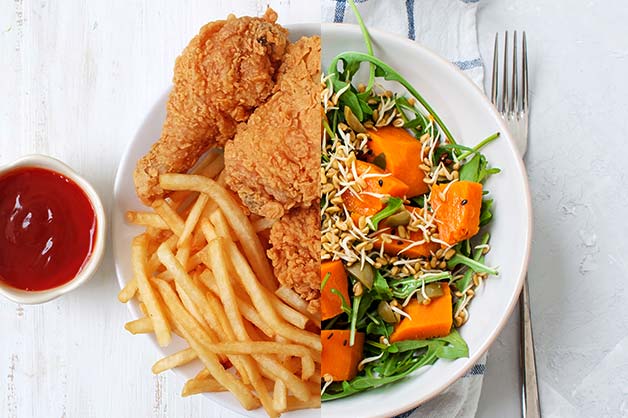 Image shows a deep fried chicken and a salad on a plate