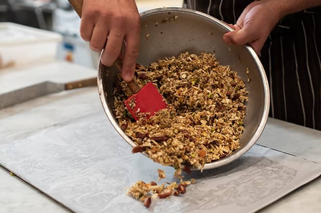Laying the White Wings Muesli mixture on a tray