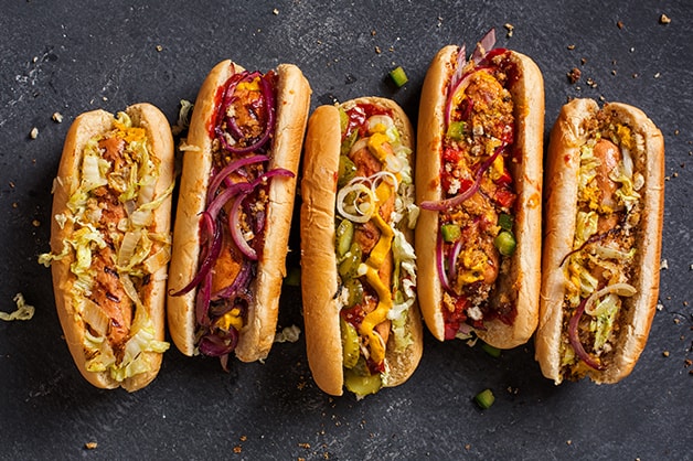 Image of five hot dogs with toppings