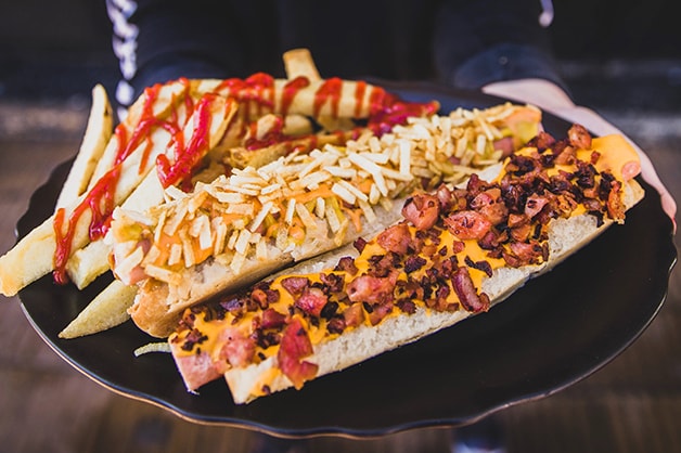 Photo of hot dog with over the top toppings
