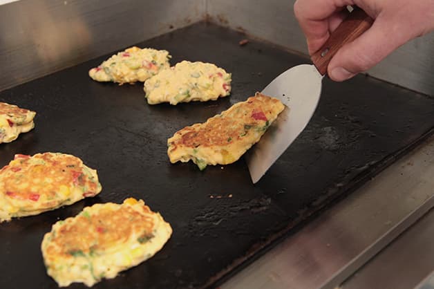 Image of the chef frying the corn fritters