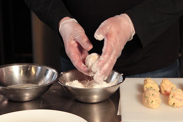 Chef coats the croquettes with White Wings Plain Flour