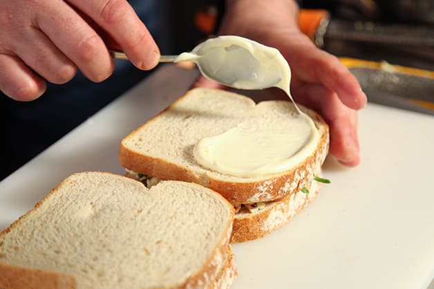 Chef spreads the Praise Mayonnaise on the bread
