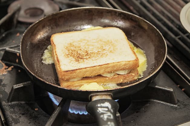 Frying the filled sandwich with butter on the stove
