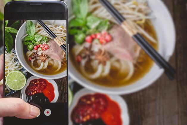 Image of a person taking a photo of food