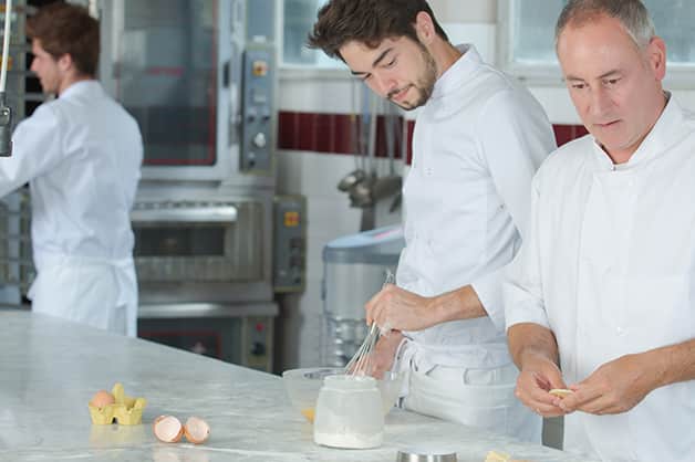 Mentoring between two chefs in the kitchen